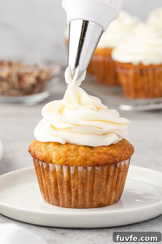 Cream Cheese Frosting Recipe for Cakes and Cupcakes 6 Cream cheese frosting piping on top of a cupcake