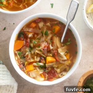 Cabbage soup in a bowl with a spoon
