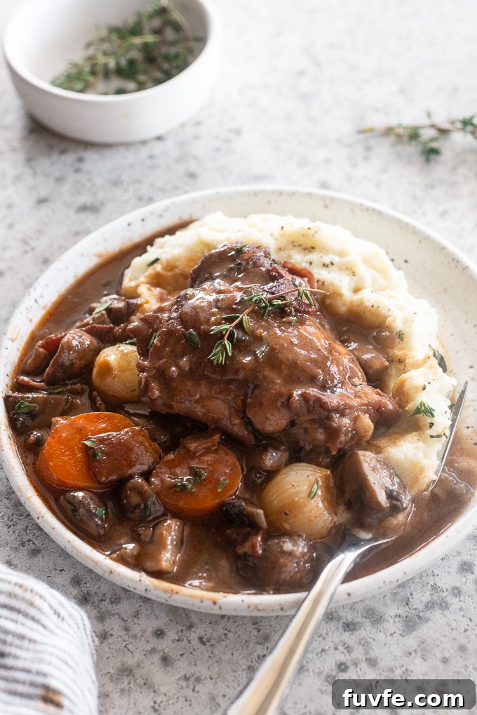 Classic Coq au Vin Recipe: French Red Wine Braised Chicken 8 Plate of Coq au Vin over mashed potatoes