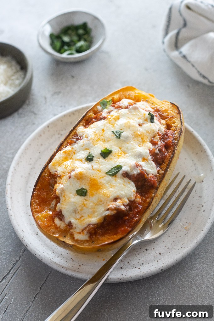 Spaghetti squash lasagna boat on a plate with a fork