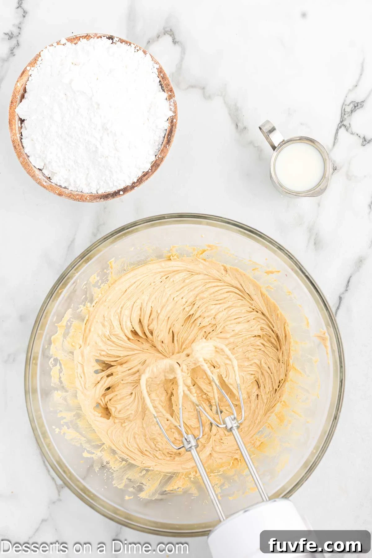 Mixing bowl with peanut butter and butter combined.
