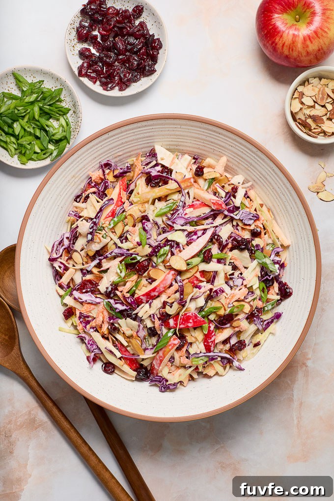 Fennel and apple slaw in a bowl with servers alongside