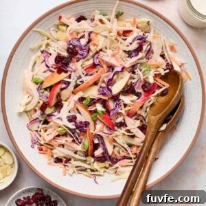 Overhead shot of apple fennel slaw in a bowl with wooden servers.