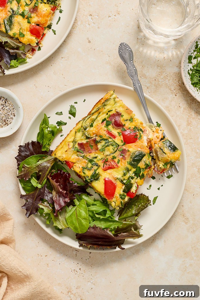 Bacon and egg bake on a plate with lettuce.