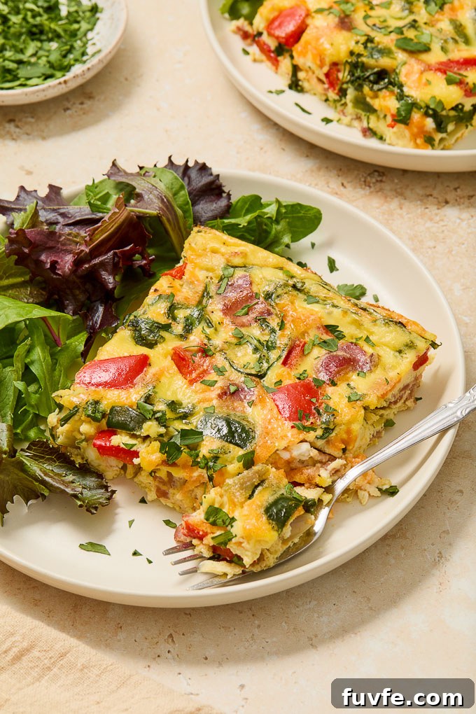Bacon and Egg Casserole on a plate with fork digging into it.
