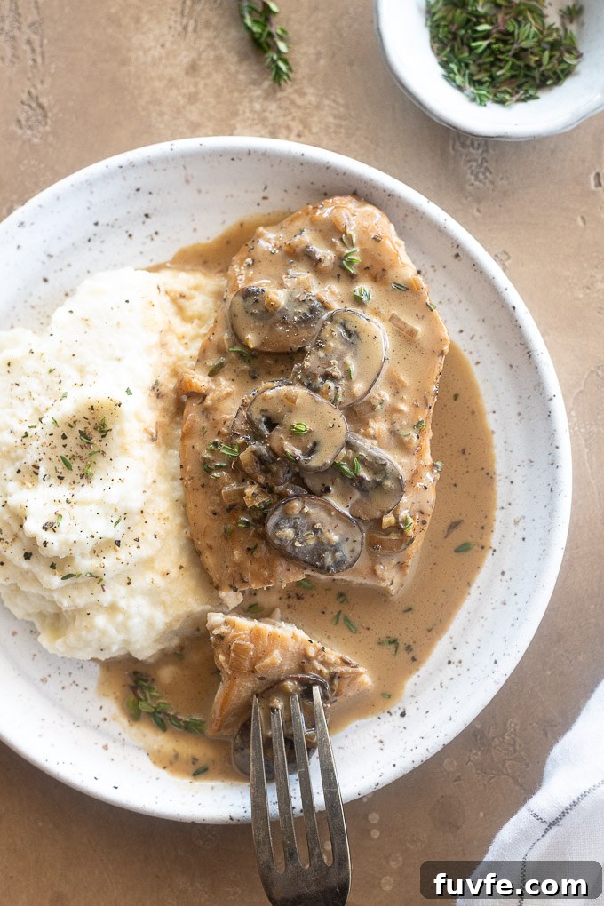 Creamy Chicken Marsala with Mushrooms 8 Creamy chicken Marsala on a plate with mashed potatoes.