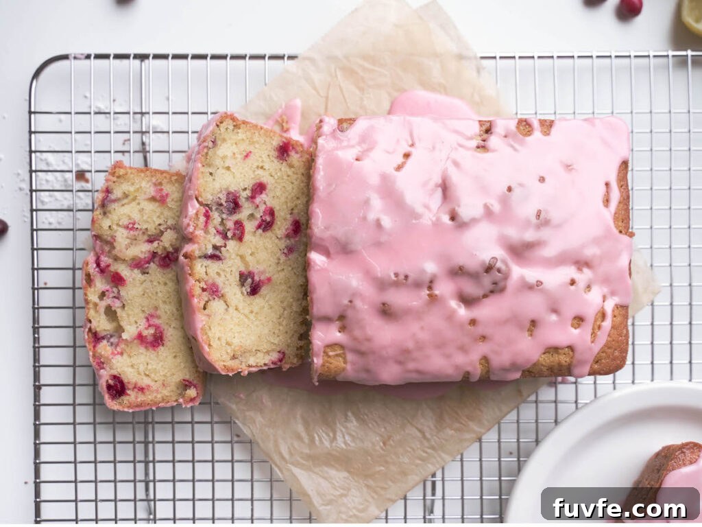 A cranberry almond loaf cake sliced open