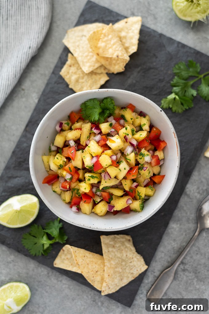 Zesty Pineapple Salsa Recipe with Lime and Cilantro 6 Pineapple salsa with chips, lime wedges and cilantro