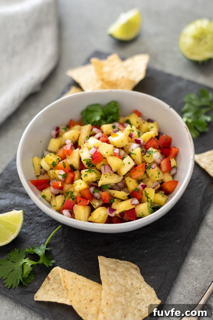 Zesty Pineapple Salsa Recipe with Lime and Cilantro 7 Bowl of pineapple salsa on a platter with chips
