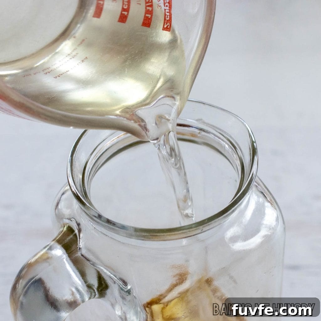 simple syrup being added to pitcher