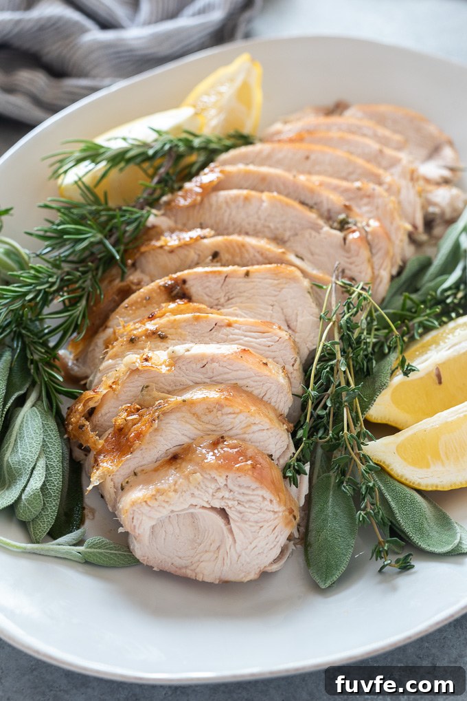 Oven roasted turkey breast sliced on white platter