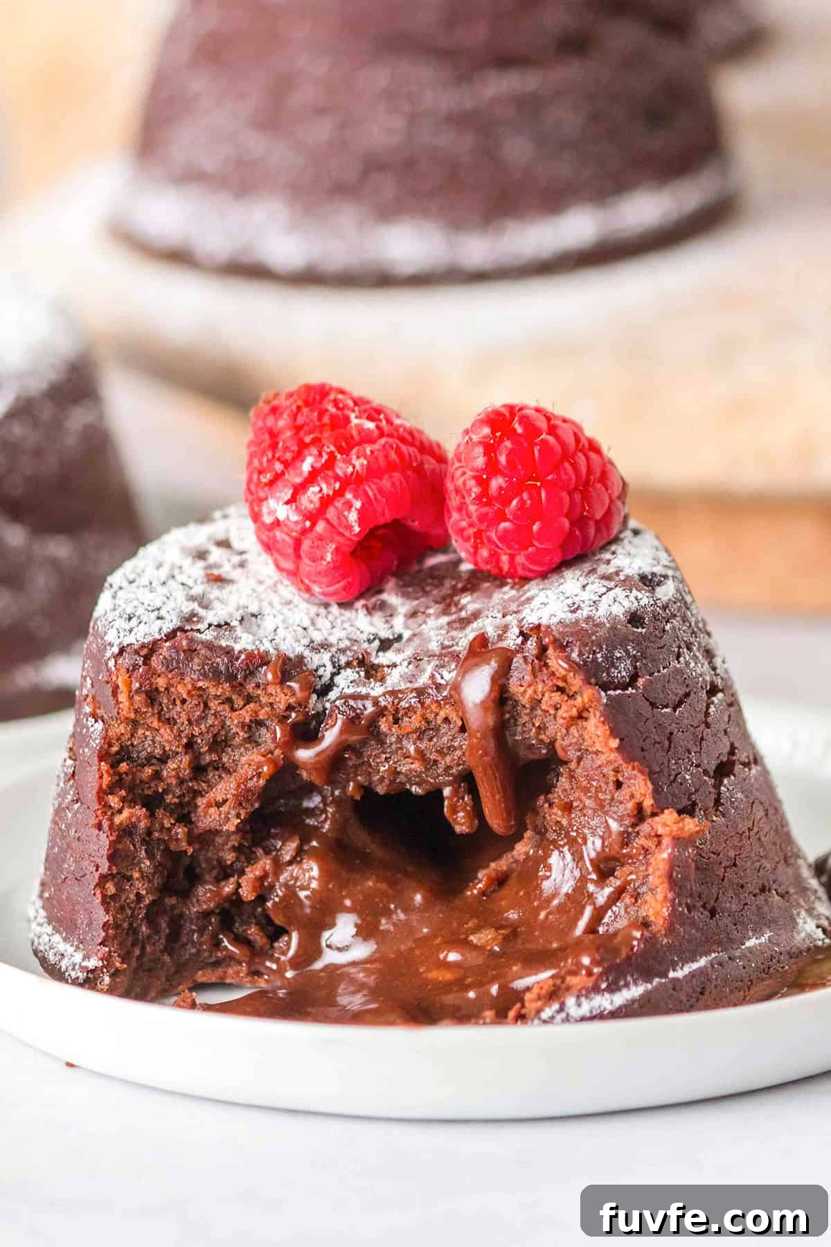 Decadent Chocolate Molten Lava Cake Recipe for Home Bakers 2 A decadent Chocolate Lava Cake topped with fresh raspberries.