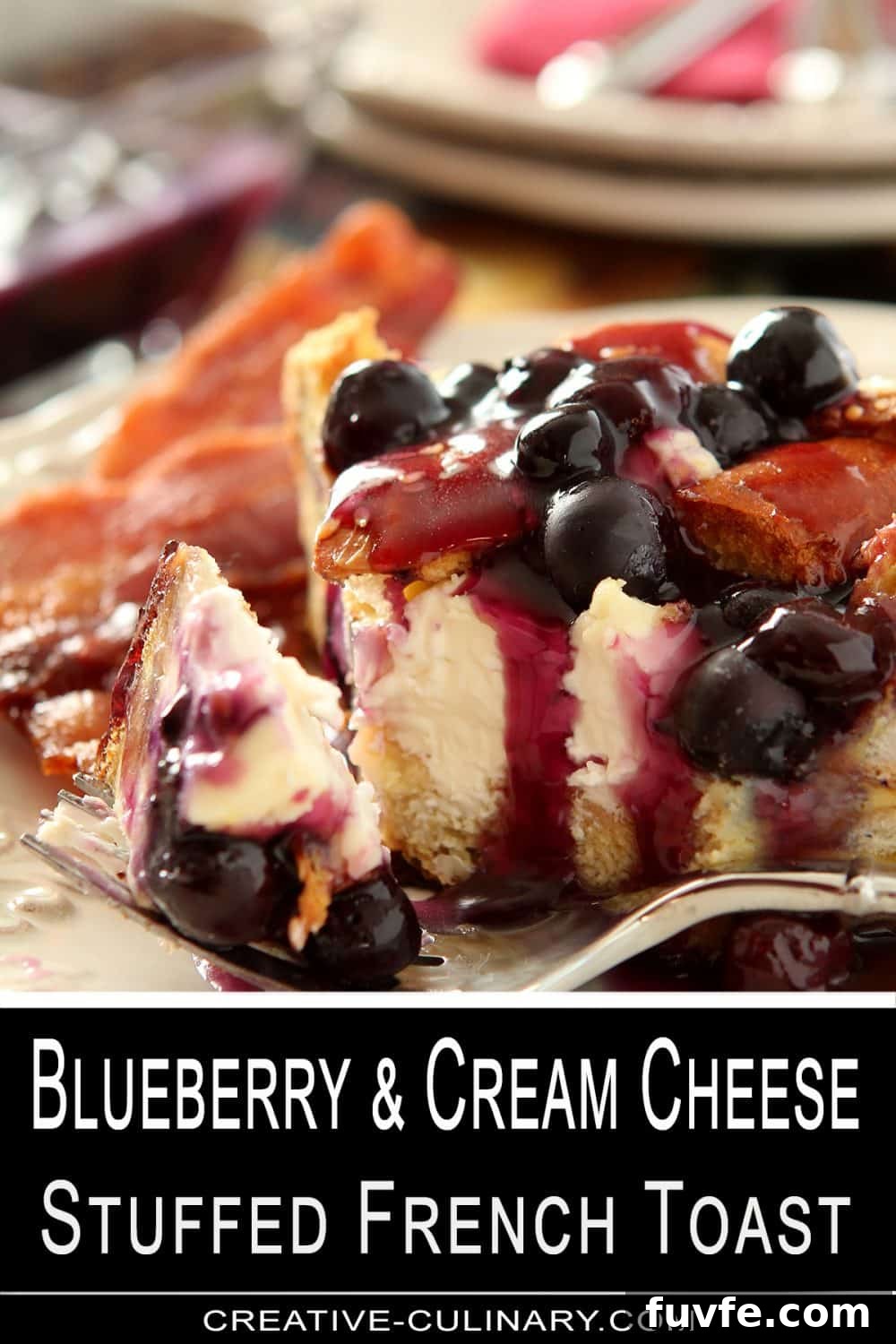 A slice of Blueberry and Cream Cheese Stuffed French Toast is on a plate with bacon strips.