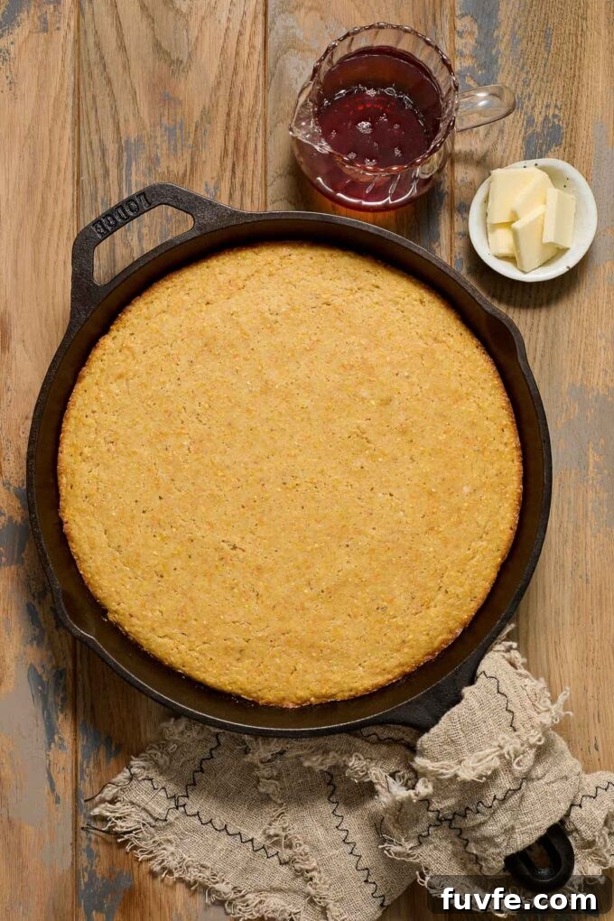 Homemade Skillet Cornbread Recipe 6 Skillet cornbread with butter and maple syrup alongside.