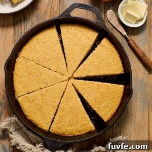 Homemade Skillet Cornbread Recipe 9 Cornbread in cast iron skillet cut into wedges.