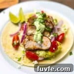 A plate of blackened chicken tacos with avocado lime crema.