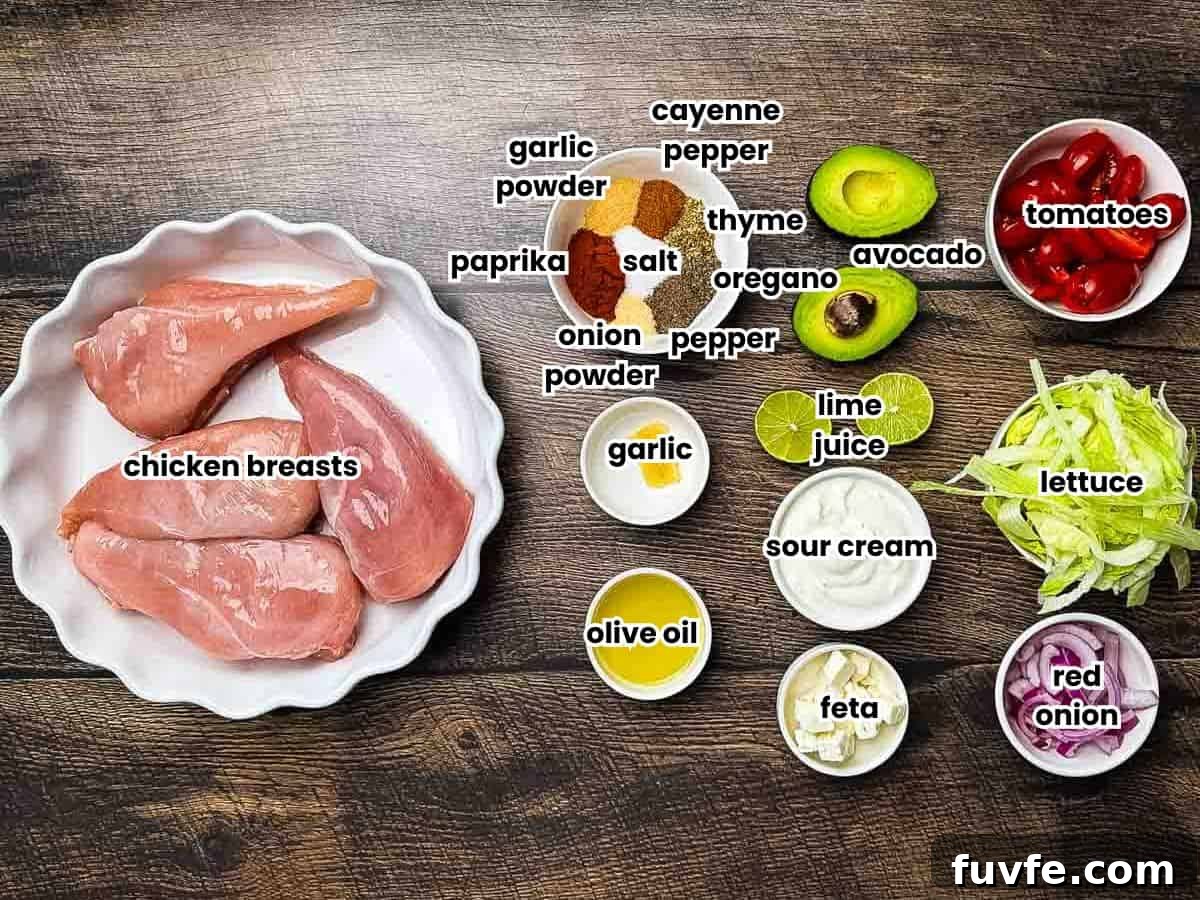 Ingredients for blackened chicken tacos and avocado lime crema labeled on a rustic wooden table.