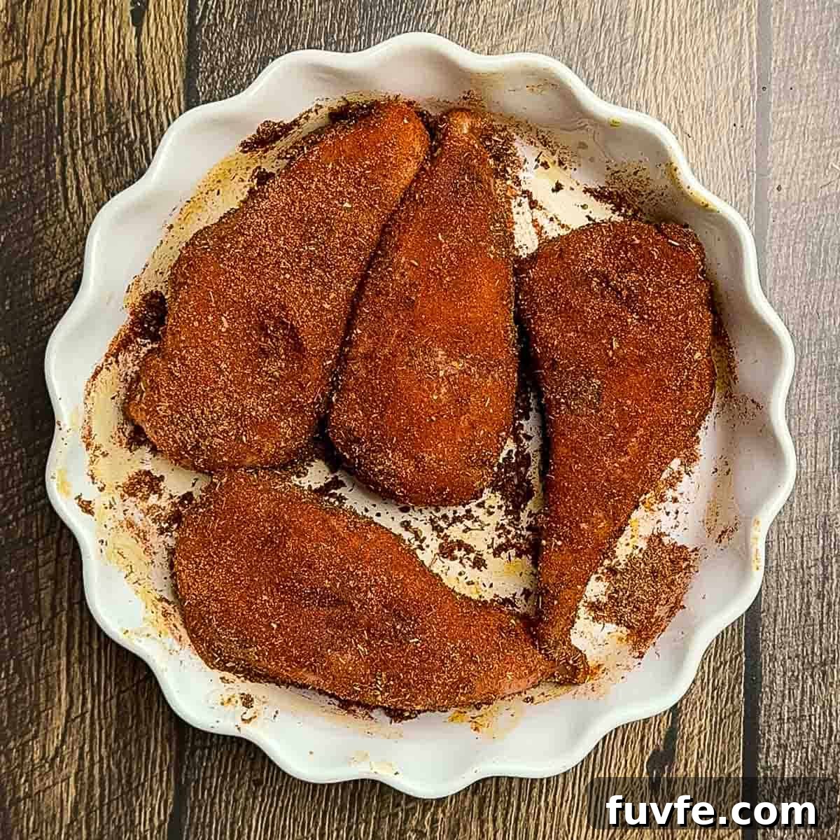 The chicken breasts covered in the homemade blackened seasoning.