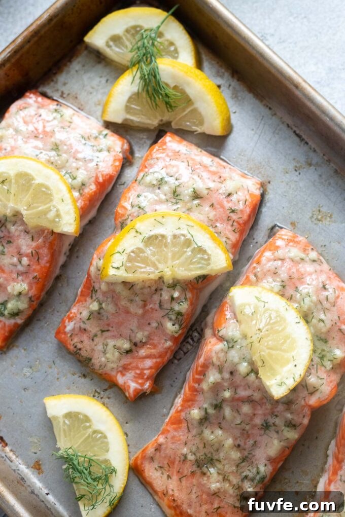 Garlic Butter Salmon Recipe for Tender, Flaky Fillets 3 Lemon garlic butter salmon on a baking sheet.