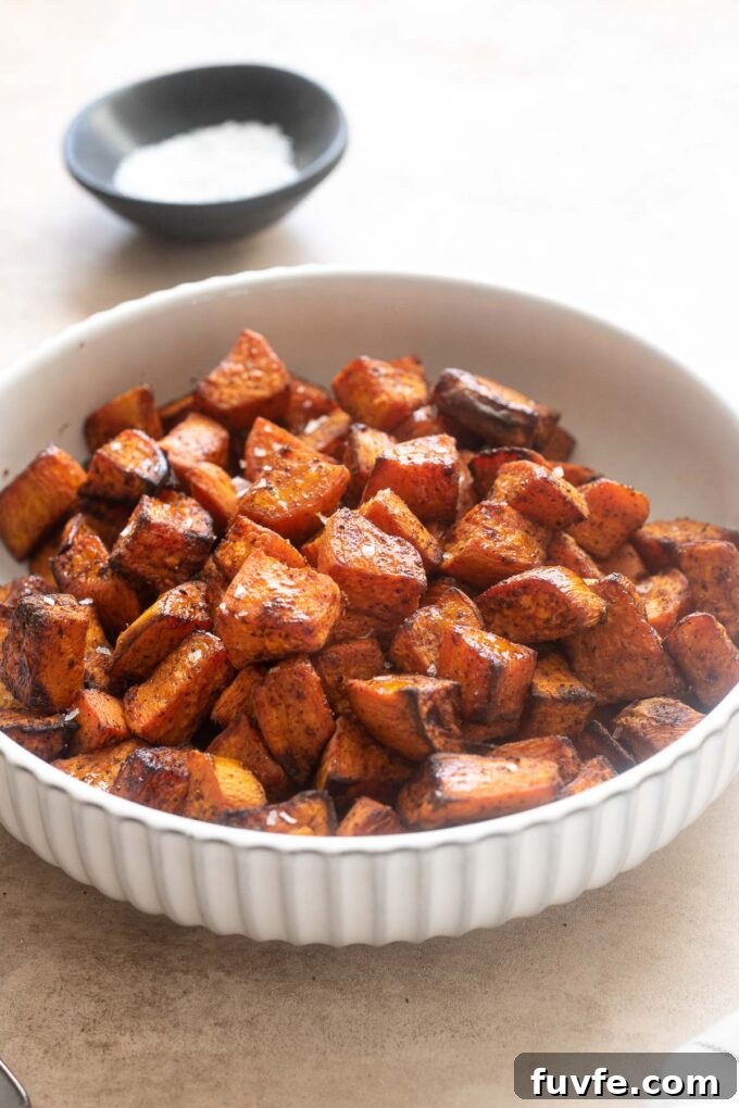 Crispy Air Fryer Sweet Potatoes 3 Air fryer sweet potato cubes in a bowl with sea salt.