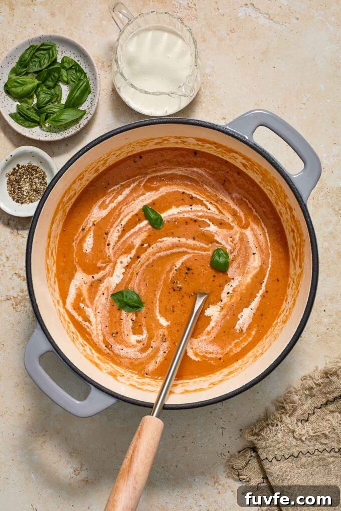 Creamy Roasted Tomato Soup Recipe with Basil 6 Roasted creamy tomato soup in a pot with ladle.