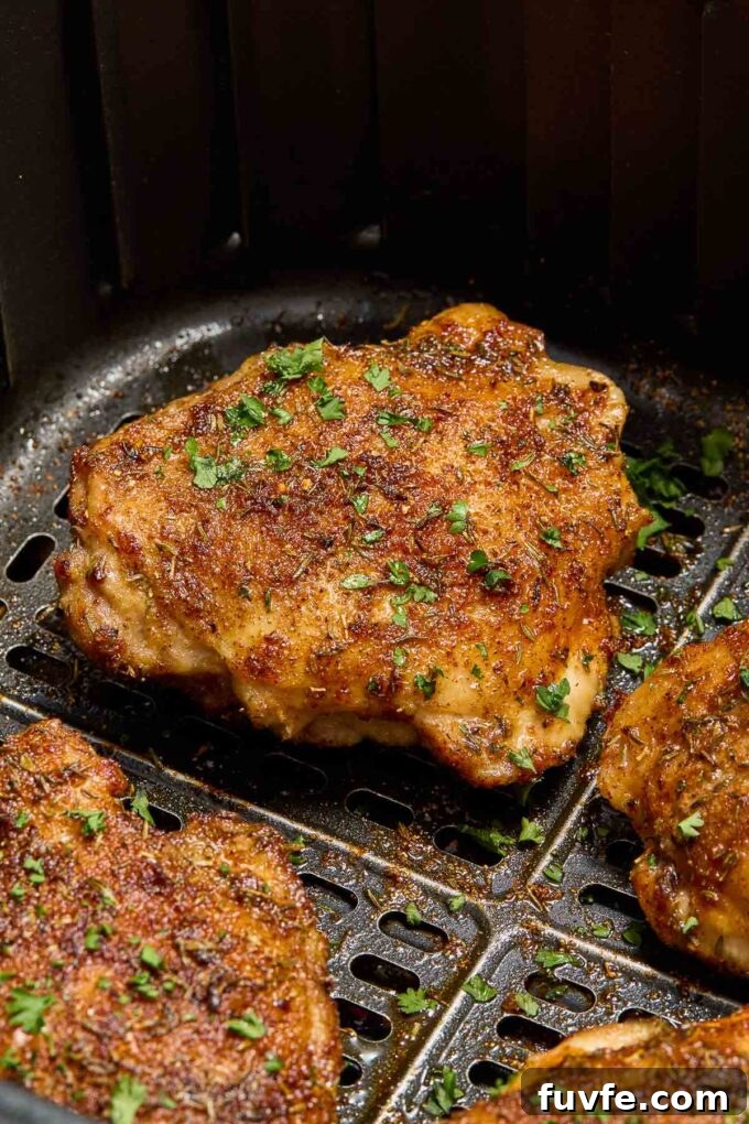 Crispy Air Fryer Chicken Thighs with Garlic and Herbs 5 Chicken thighs in the air fryer.