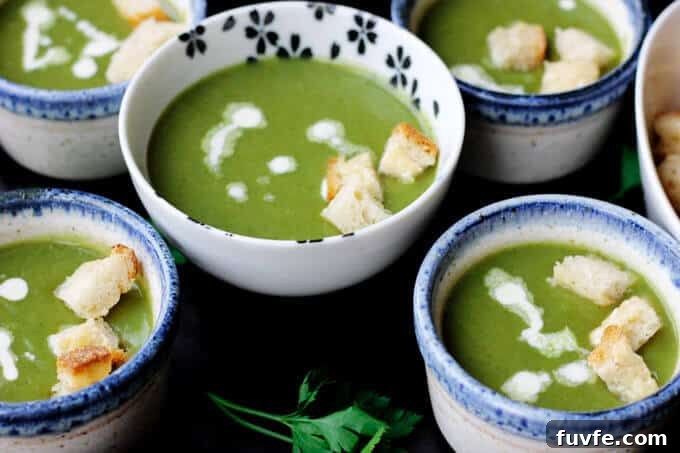 Creamy spinach soup with croutons on bowls
