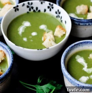 Creamy spinach soup with croutons on bowls