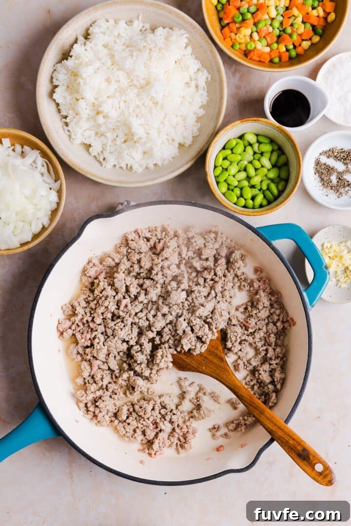 Savory Ground Turkey Fried Rice Recipe — Quick Weeknight Meal 6 Ground turkey cooked and crumbled in a large pan
