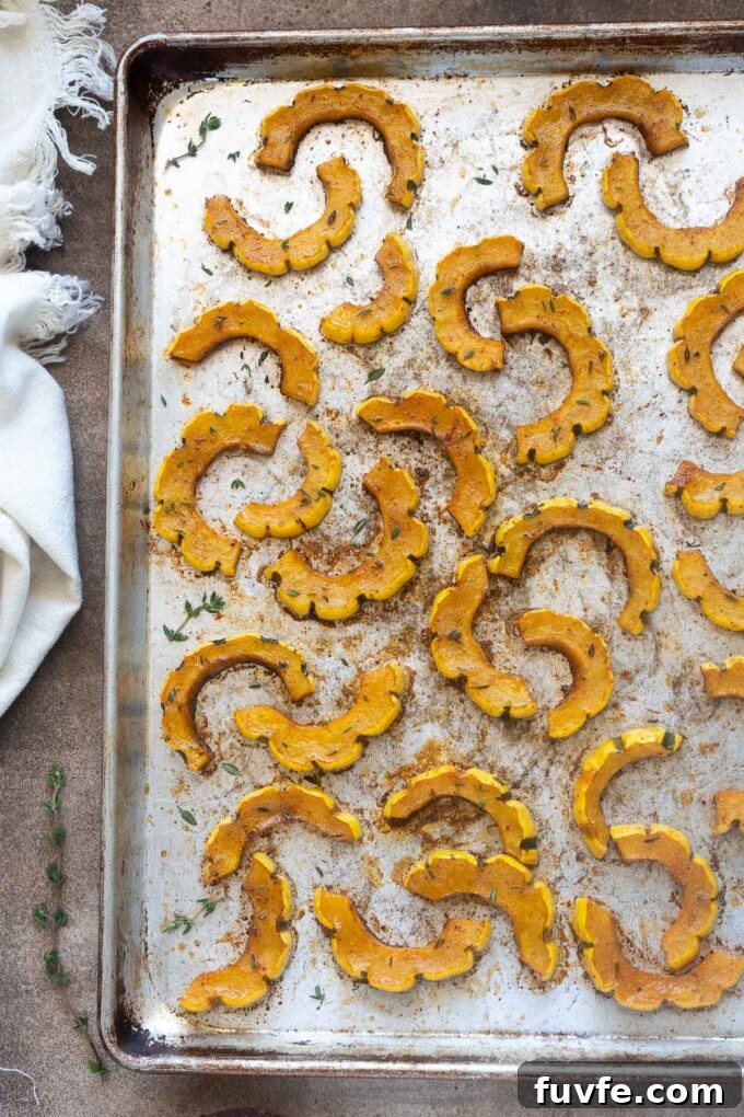 Roasted Delicata Squash with Maple Glaze 3 Oven Roasted Delicata Squash on a sheet pan.