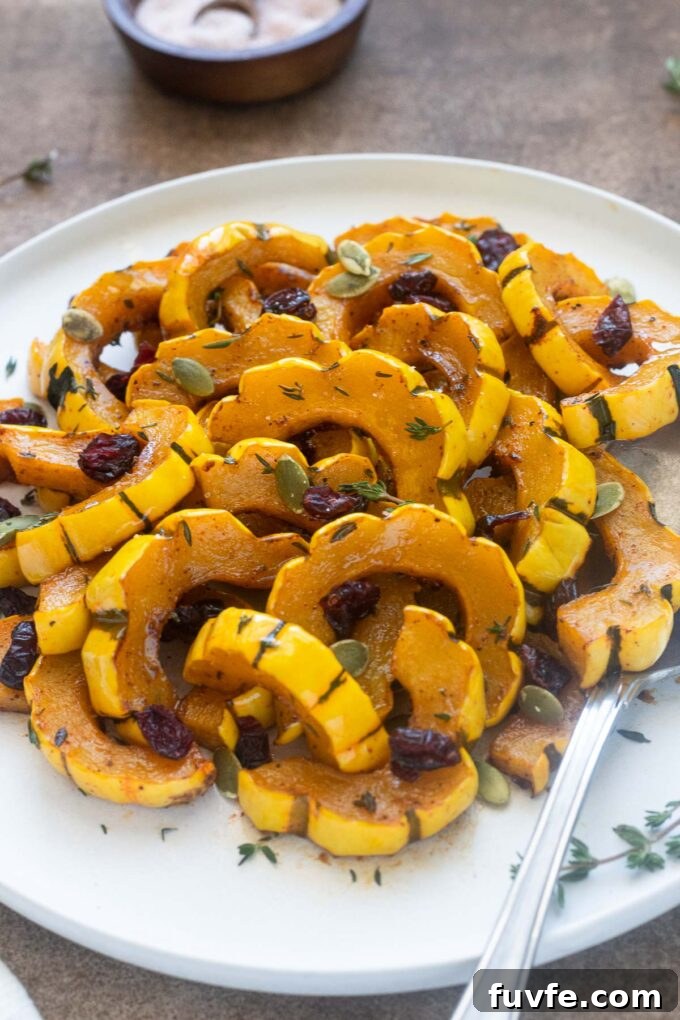 Roasted Delicata Squash with Maple Glaze 7 Maple roasted delicata squash with dried cranberries and pepitas.