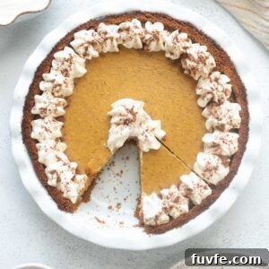 Pumpkin cheesecake pie with a slice cut out.