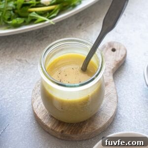 Homemade Honey Champagne Vinaigrette Recipe for Salad Dressing 7 Honey champagne vinaigrette in a jar with a spoon.