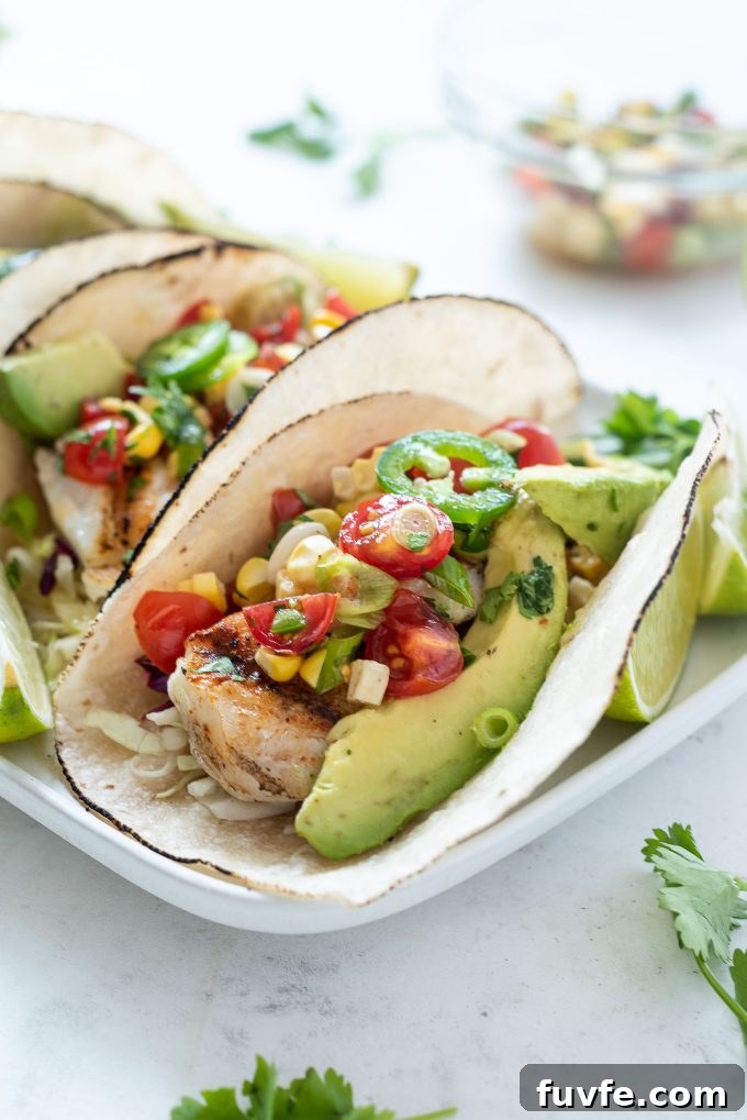 Grilled Fish Taco topped with cherry tomato salsa and avocado