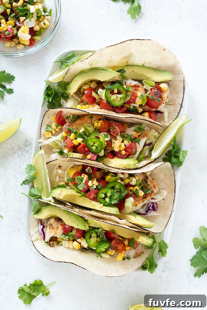 Four cod fish tacos on a platter