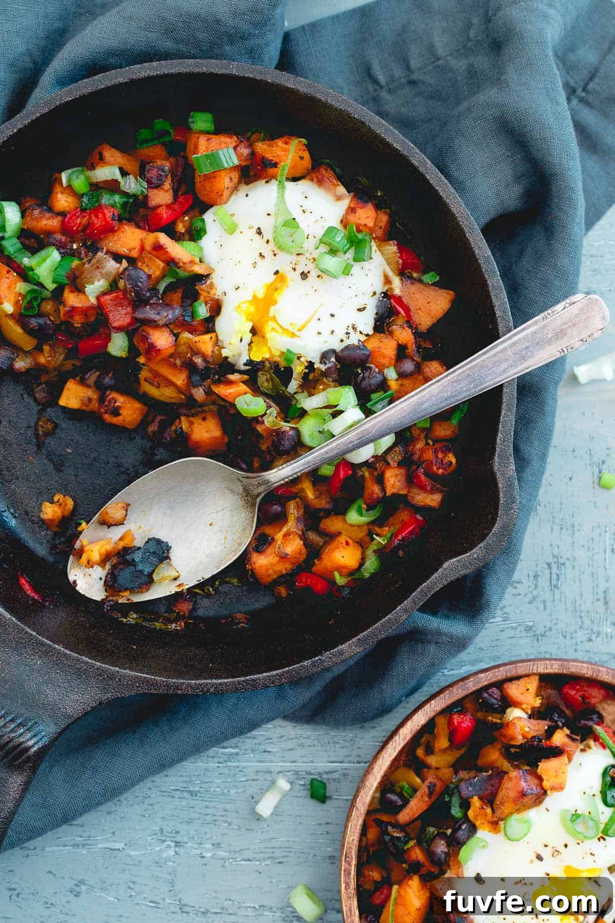 With a couple runny eggs on top, this harissa sweet potato hash is simple, spicy and perfect for a quick meal any time of day!