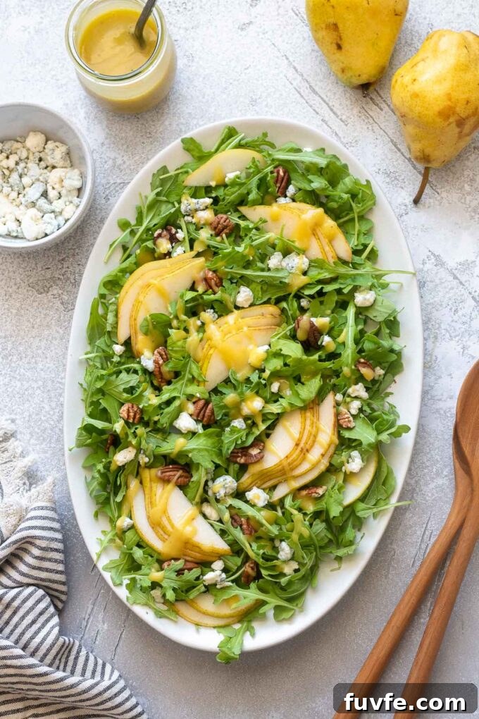 Arugula and Pear Salad with Honey-Balsamic Dressing 6 Pear and blue cheese salad on a platter.