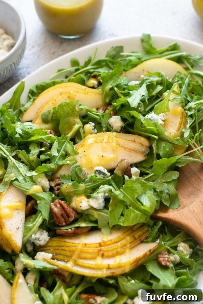 Arugula and Pear Salad with Honey-Balsamic Dressing 7 Pear blue cheese salad with arugula and pecans.