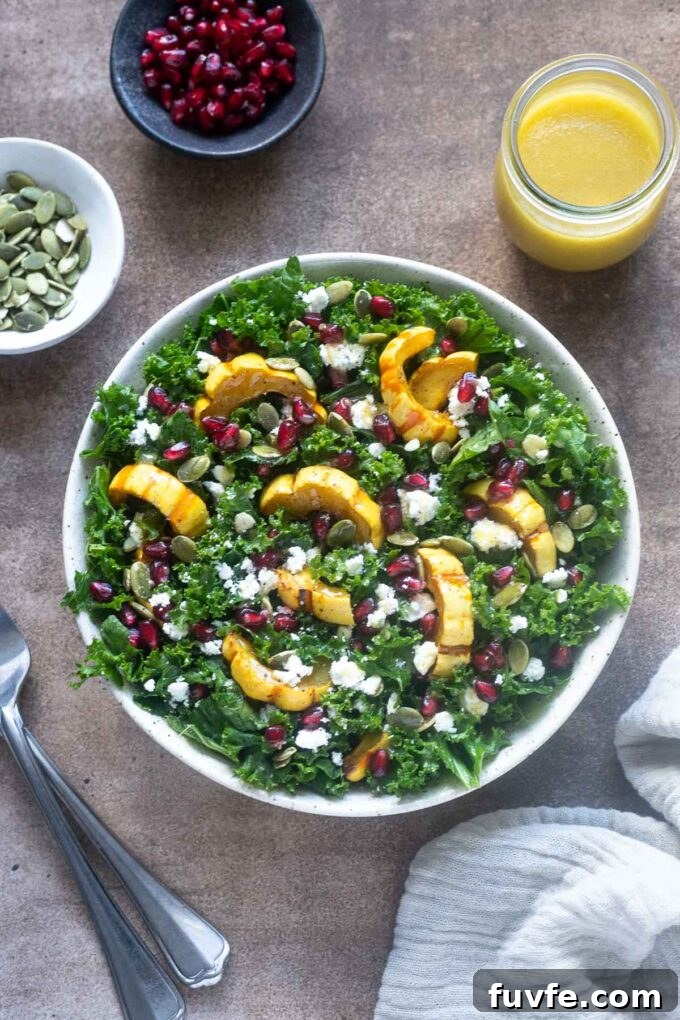 Delicata squash salad in a bowl with dressing alongside.