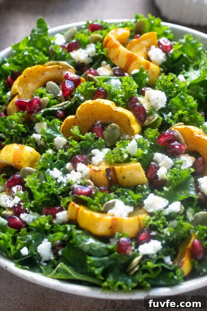 Delicata squash kale salad with feta cheese and pomegranate.