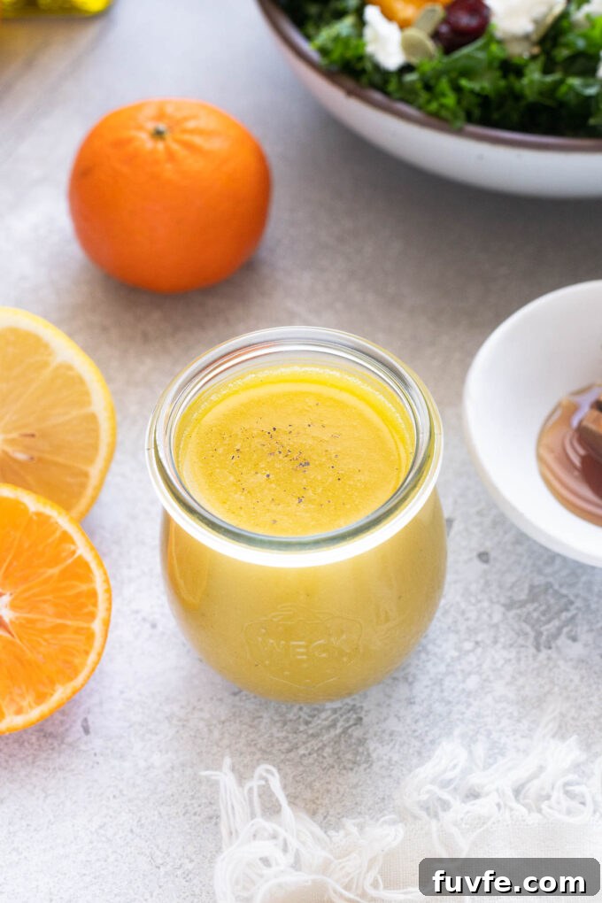 Zesty Citrus Vinaigrette Recipe for Salads and Marinades 3 Citrus vinaigrette in a jar with black pepper sprinkled on top.