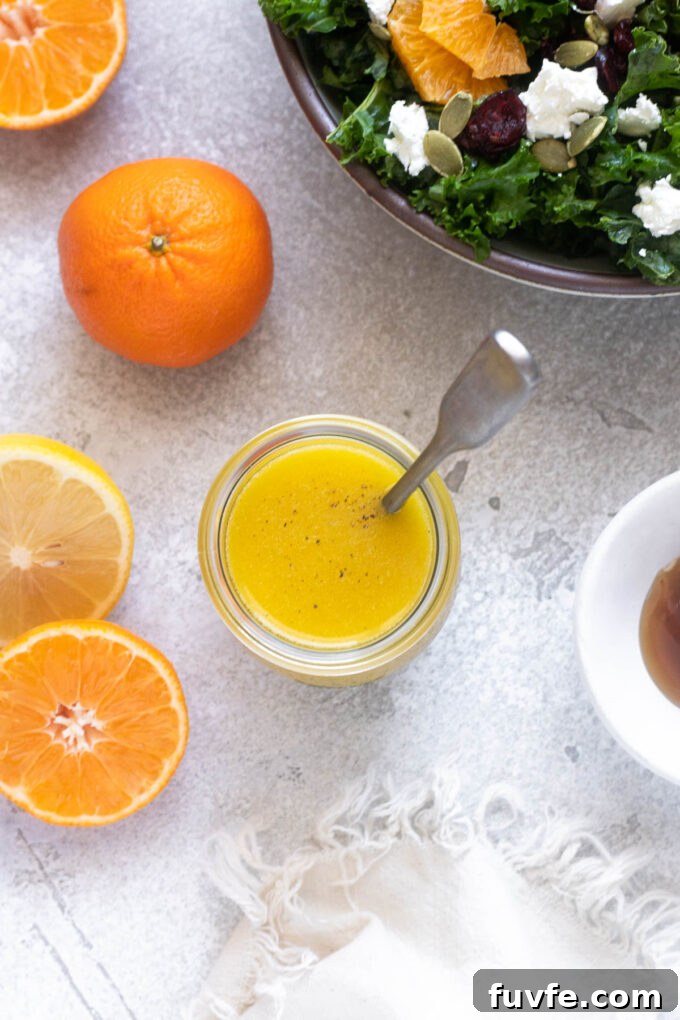 Orange dressing in a jar with a spoon.