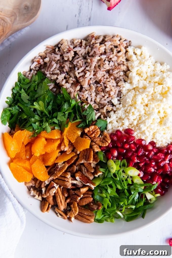 Wild Rice Salad with Orange and Pomegranate Recipe 3 Wild rice salad ingredients segmented in a bowl