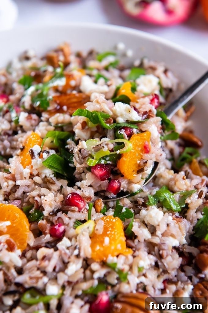 Wild Rice Salad with Orange and Pomegranate Recipe 7 Spoonful of wild rice salad over a bowl