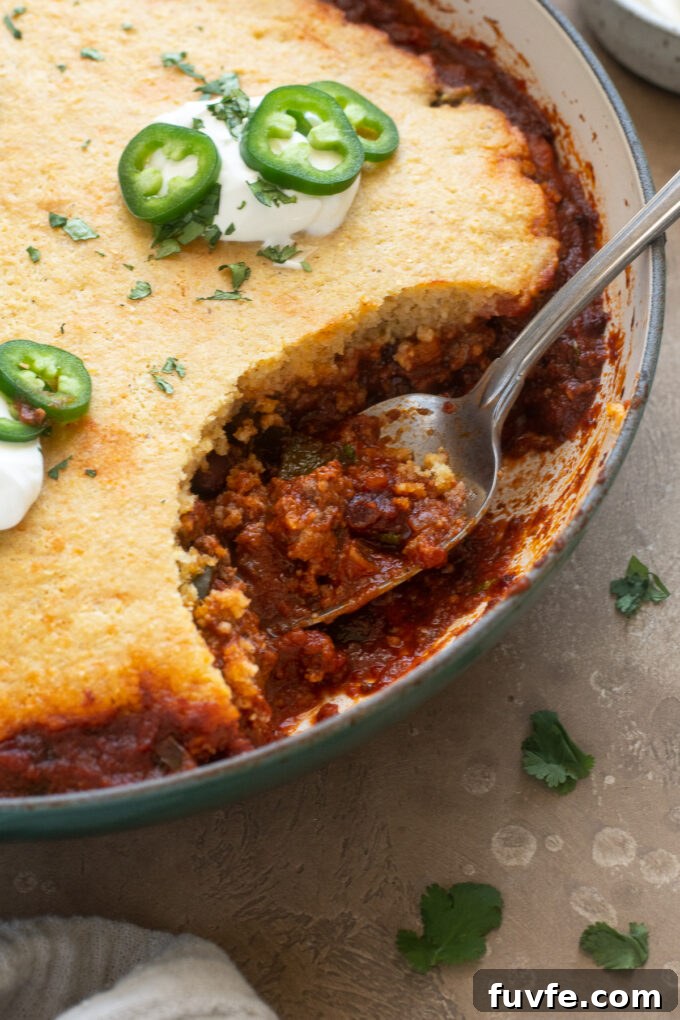 Cheesy Chili Cornbread Casserole Recipe 3 Chili casserole with cornbread topping in a skillet.