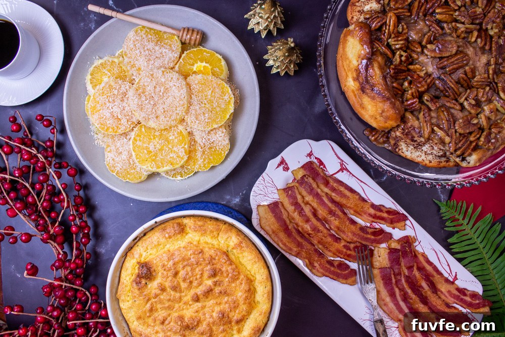 Christmas breakfast table egg souffle, sticky pecan rolls, oranges and bacon 