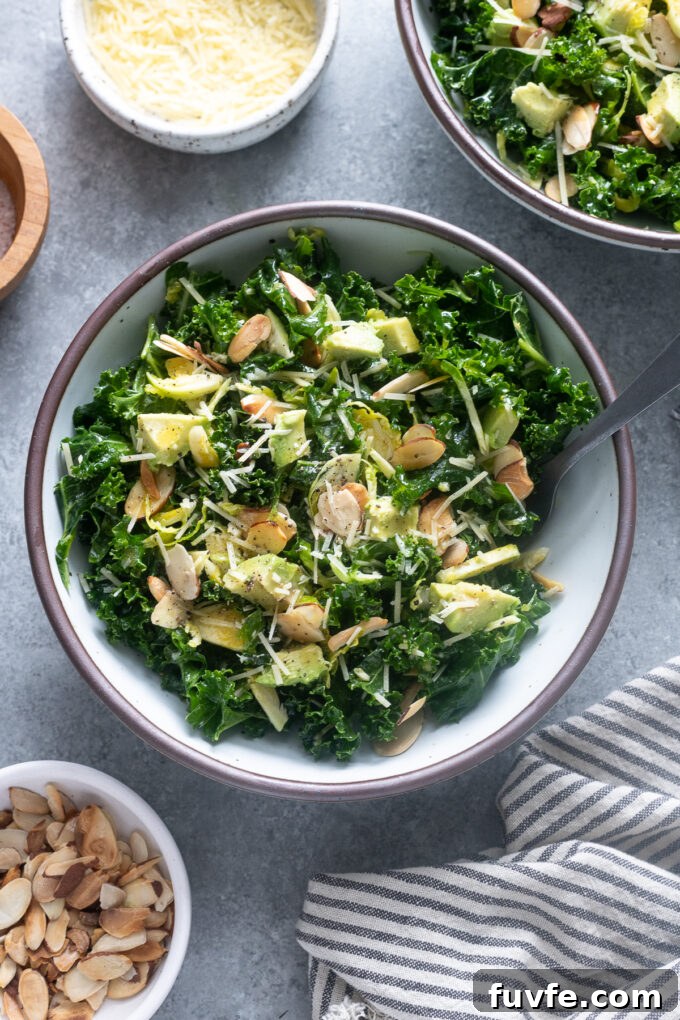 Kale and raw brussels sprout salad in a bowl with a fork.