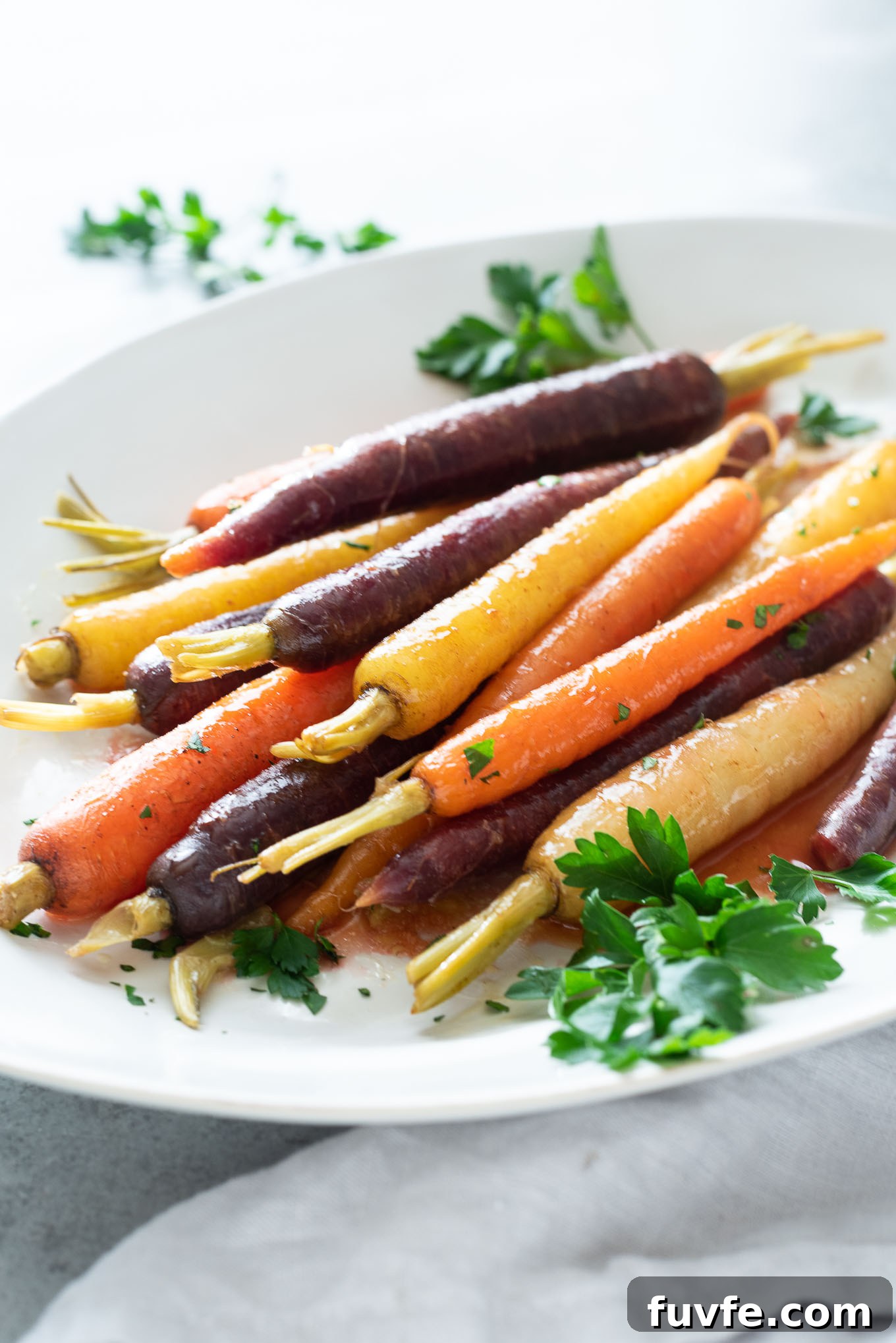 What's In Season in March: Fresh Produce Guide 13 Maple glazed carrots on a platter with fresh parsley