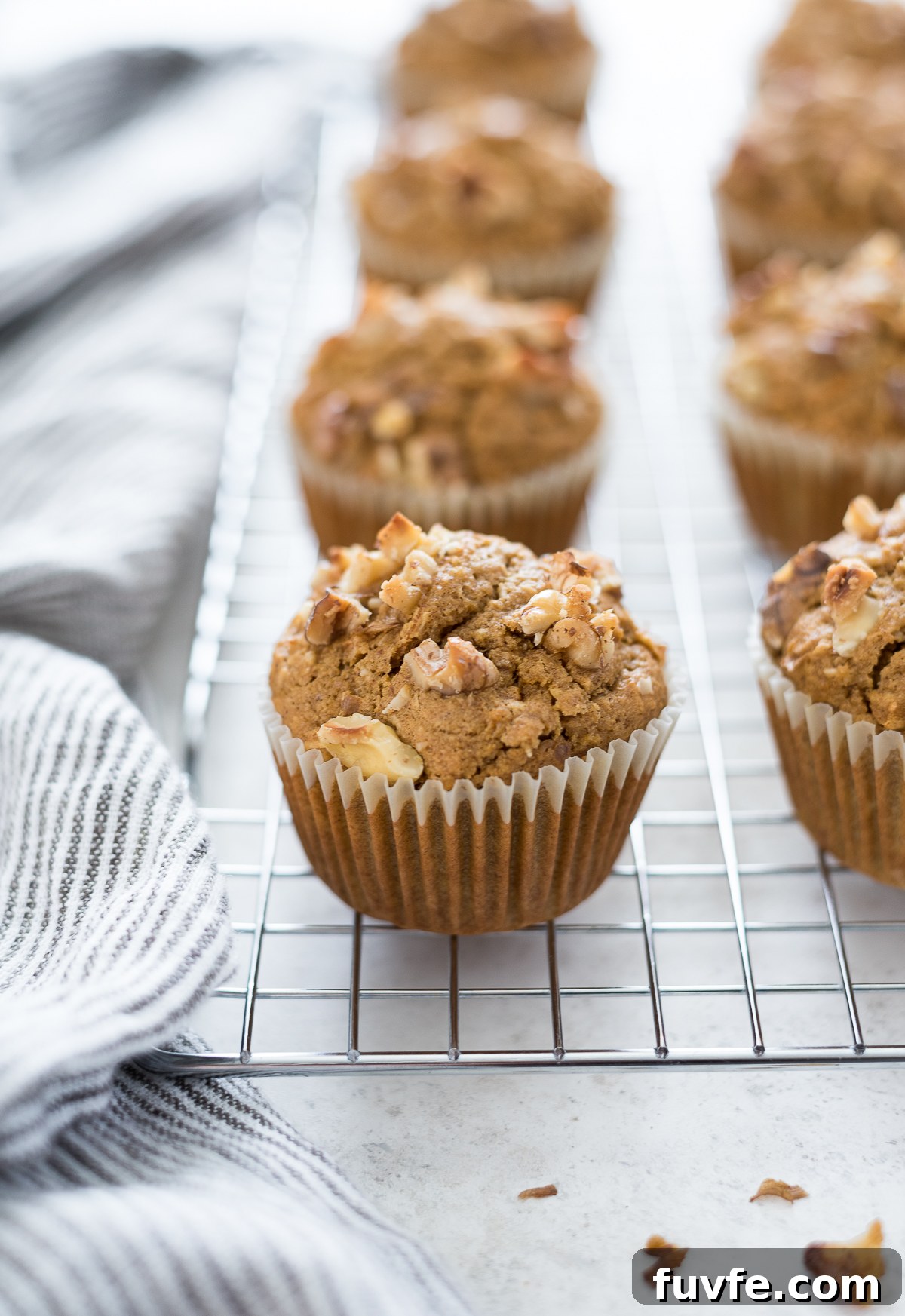 What's In Season in March: Fresh Produce Guide 14 Carrot oat flour muffins on a wire rack.