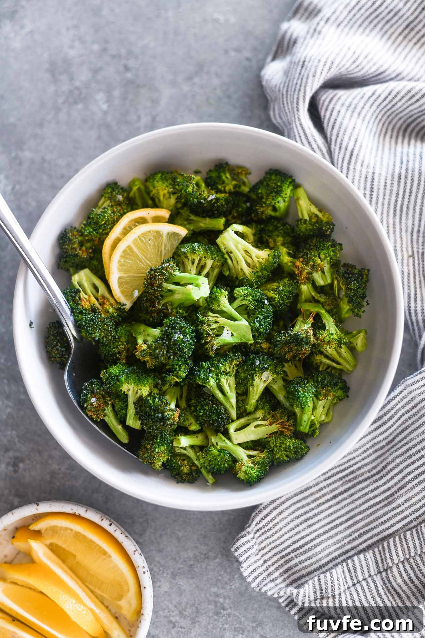 What's In Season in March: Fresh Produce Guide 16 Serving spoon buried in a bowl of air fryer broccoli